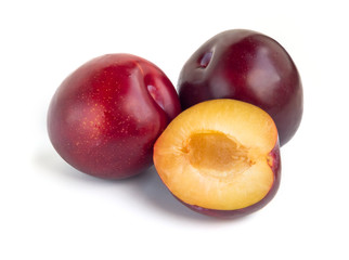 Three plums isolated on white background