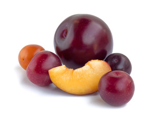 Several varieties of plums isolated on white background