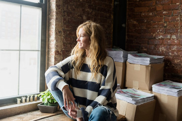 Business owner looking out window