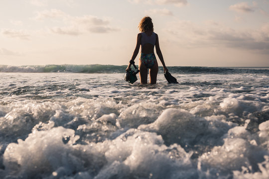 Woman surf photographer at the beach of tropical island - Powered by Adobe