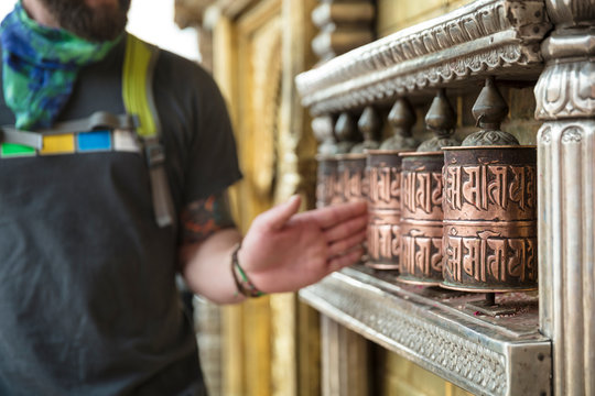 Tourist Spinning Buddhist Prayer Wheels in Nepal