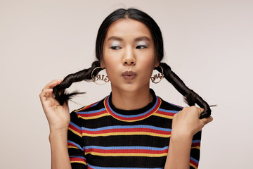 Close up of young woman holding her hairs