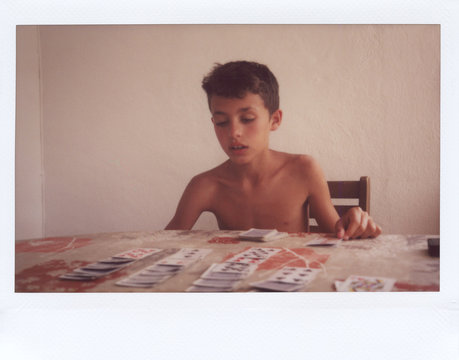 Boy playing cards.