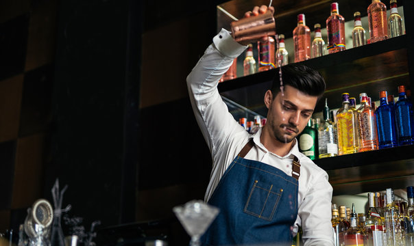 Young bartender working in bar