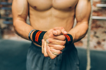 Midsection of man clasping hands with talc