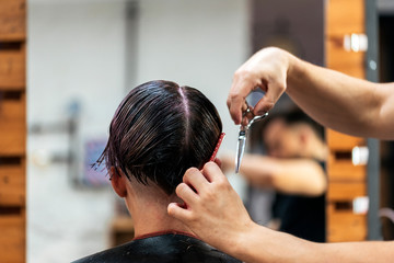 Woman getting haircut by hairdresser in salon