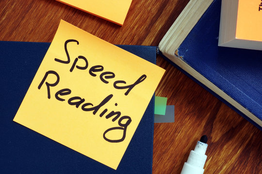 Book and piece of paper with sign speed reading.