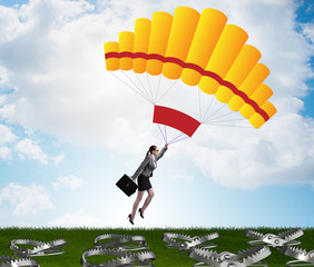 Businesswoman falling into trap on parachute