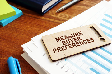 Measure Buyer Preferences sign. Behavior Research on an office desk.