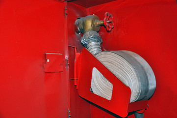 Fire hose in a twisted state in a fire shield.