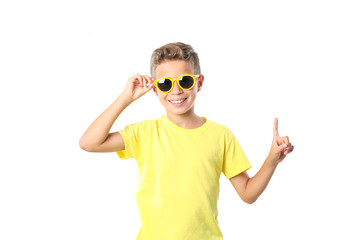 Boy in yellow t-shirt with sunglasses isolated on white background