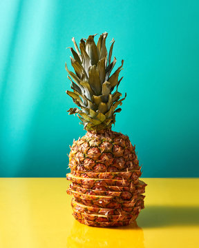 Tropical Pineapple fruit single whole, made up of slices on a du