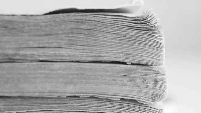 Old book macro shot, texture of old book paper. Extreme closeup, Slow pan, selective focus. Concept of reading, knowledge, wisdom, history, archive, memory and book storage.