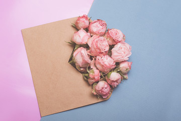 Envelope of craft paper with pink roses. Congratulation with wedding, birthday, valentines day.