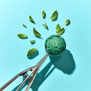 Flat lay view of spoon for ice cream with green mint dessert and