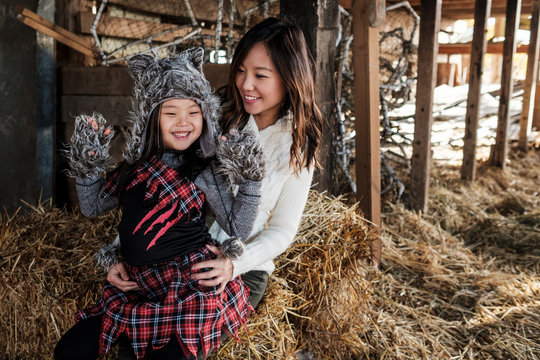 Asian Mother and Daughter Pumpkin Patch During Fall Season