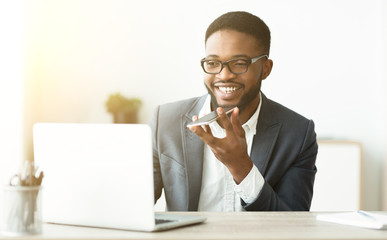 African Man Using Voice Assistant On Cellphone