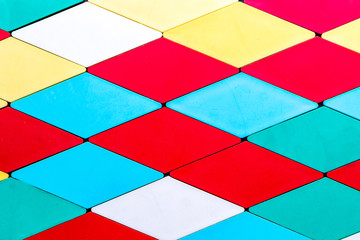 textural background of geometric shapes of different colors in the form of rhombuses