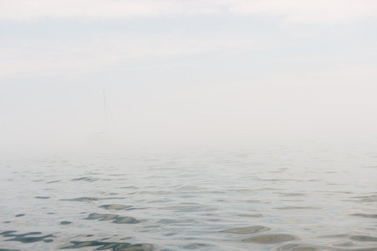 Ghostly outline of  a yacht on a foggy Lake Ontario