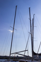 High masts of yachts against a blue sky