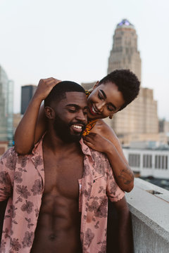 A young black couple watching the sun set in the city
