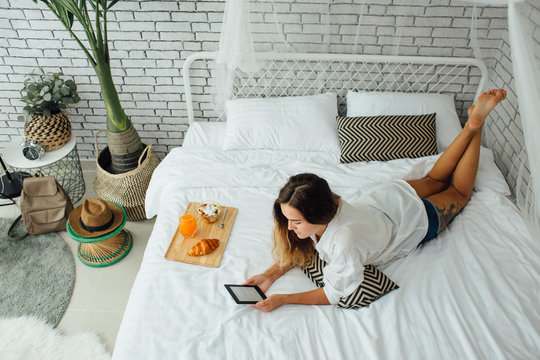Woman using ereader in bed