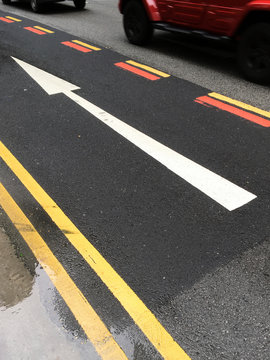 One way arrow in wet road.