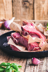 Raw veal steaks, preparing food