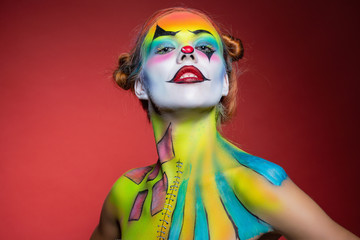 Beautiful young woman with a aqua makeup clown.