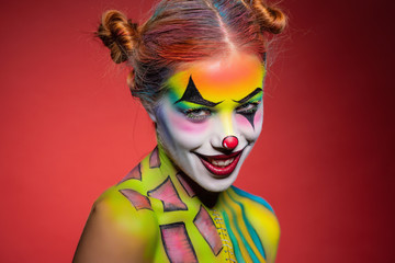 Obraz premium Pretty young lady with a face painting clown.