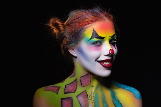 Smile woman with a body art clown.