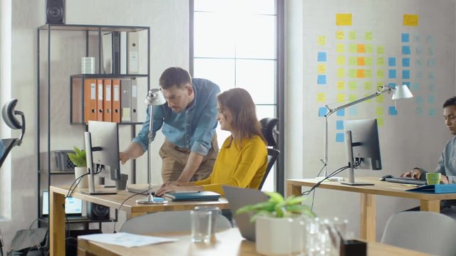 Group of Professional Employees Working on Desktop Computers, Walking Through Busy Office. Talking With Colleagues, Designing Software, Performing Customer Support, Emailing Clients, Marketing Sales