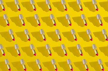 Collage red lipstick in gold tube on yellow background