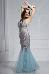 Gorgeous young woman poses in a studio.