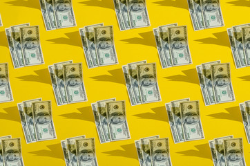 Collage one hundred dollars pattern on yellow background