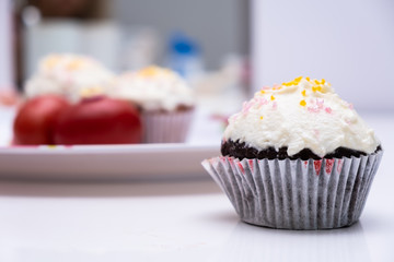 Cake. Cup cake on white table, on white background.