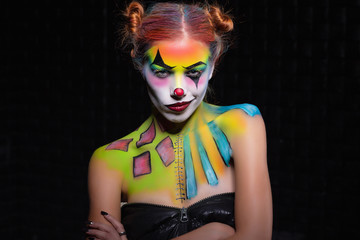 Fototapeta na wymiar Nice lady with a face painting clown.