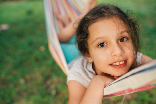 Smiling Little Girl Lying In Hammock