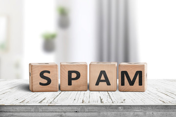 Spam sign on a white desk with wooden blocks