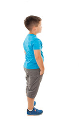 Adorable little boy looking at wall. Isolated on white background 