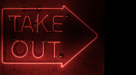 A grimy neon arrow with 'Take Out' written inside.