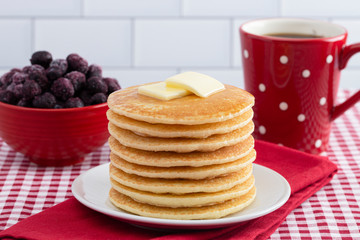 A Stack of Freshly Made Pancakes on a Gingham Tablecloth