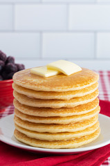A Stack of Freshly Made Pancakes on a Gingham Tablecloth