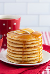 A Stack of Freshly Made Pancakes on a Gingham Tablecloth