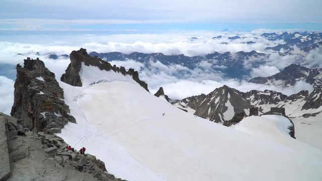 A group of climbers is on the glacier. They climb to the top of the Grand Paradiso in the Italian Alps. 4K