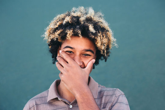 Shy afro teenager laughing
