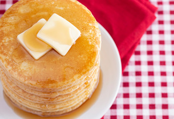 A Stack of Freshly Made Pancakes on a Gingham Tablecloth