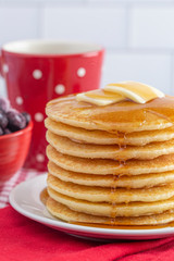 A Stack of Freshly Made Pancakes on a Gingham Tablecloth