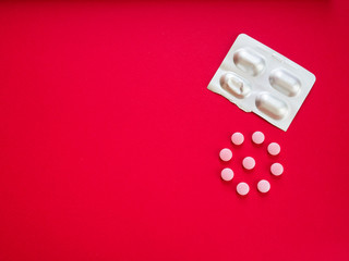 pills on red copy space top view