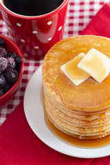 A Stack of Freshly Made Pancakes on a Gingham Tablecloth